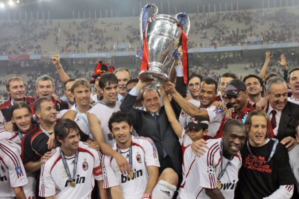 AC Milan’s Silvio Berlusconi raises the trophy aloft as he stands with his team after they beat Liverpool 2-1 to win the Champions League Final soccer match between AC Milan and Liverpool at the Olympic Stadium in Athens, on May 23, 2007. (Luca Bruno/AP Photo)