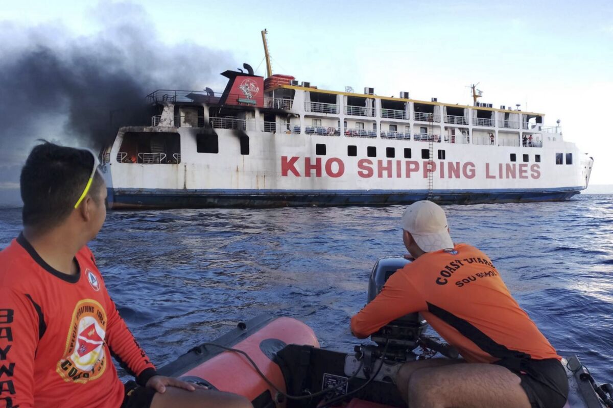 Coast guard personnel assist in putting out the fire on Philippine ferry M/V Esperanza Star at the waters off Panglao, Bohol province, central Philippines, on June 18, 2023. (Philippine Coast Guard via AP)