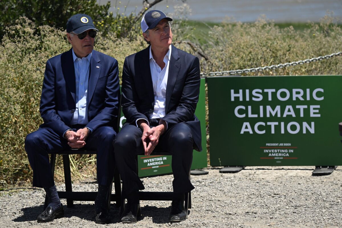 President Joe Biden (L) and California Gov. Gavin Newsom listen to a speaker before Biden delivers remarks on his administration's environmental efforts at the Lucy Evans Baylands Nature Interpretive Center and Preserve in Palo Alto, Calif., on June 19, 2023. (Andrew Caballero-Reynolds/AFP via Getty Images)