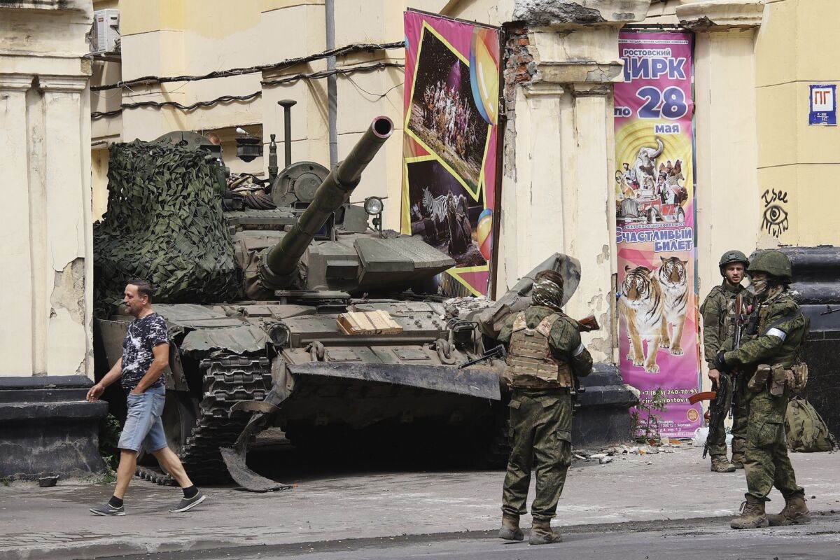 Russian servicemen guard an area standing in front of a tank in a street in Rostov-on-Don, Russia, on June 24, 2023. (Vasily Deryugin, Kommersant Publishing House via AP)