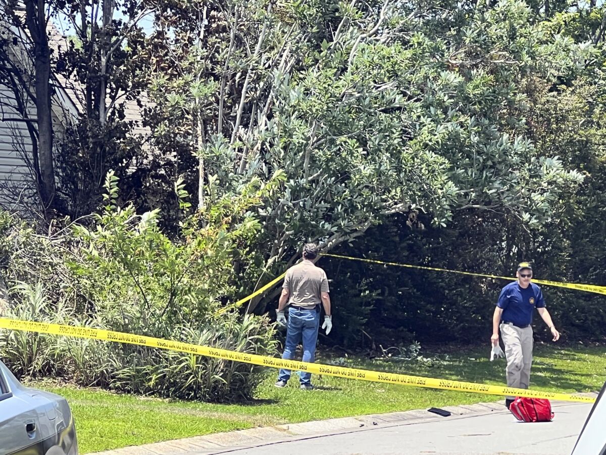 Investigators with the National Transportation Safety Board and the Federal Aviation Administration work at a plane crash site at a home near Southport, N.C., on June 26, 2023. (Renee Spencer/The Star-News via AP)