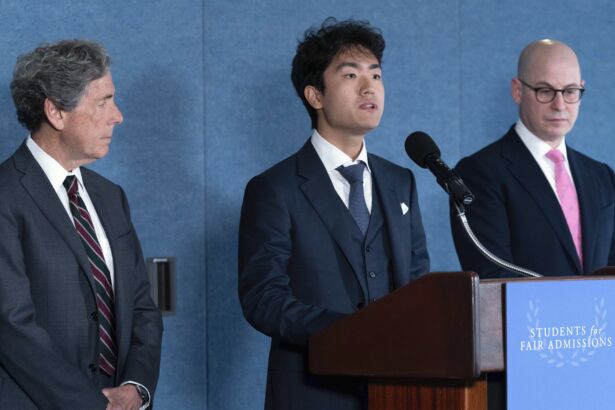 Berkeley University student Calvin Yang, center flanked by Edward Blum (L) and Adam Mortaraw (R), speaks during a news conference on Supreme Court affirmative action in college admissions decision at the Press Club in Washington on June 29, 2023. (Jose Luis Magana/AP Photo)