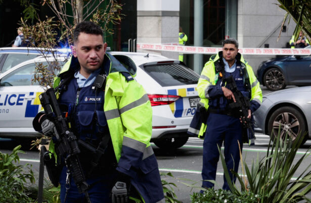 Armed police stand guard near a construction site following a shooting in the central business district, in Auckland, New Zealand, on July 20, 2023. (David Rowland/Reuters)