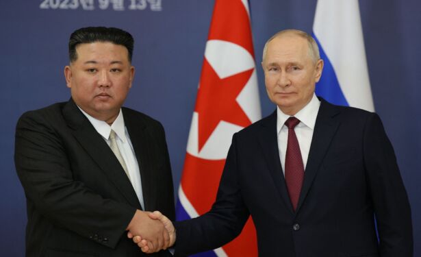 id941655-putin-shakes-hand-with-kim-jong-un