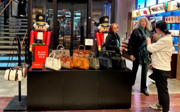 Shoppers pause near a display of handbags at a Coach store in New York on Nov. 19, 2023. (Anne D'Innocenzio/AP Photo)