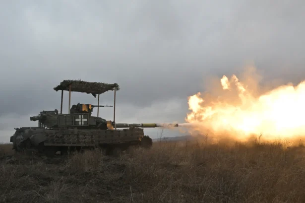 Ukrainian servicemen fire with a tank