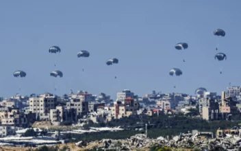 Parachutes drop supplies into the northern Gaza Strip on March 10, 2024, as seen from southern Israel. (Ariel Schalit/AP Photo)