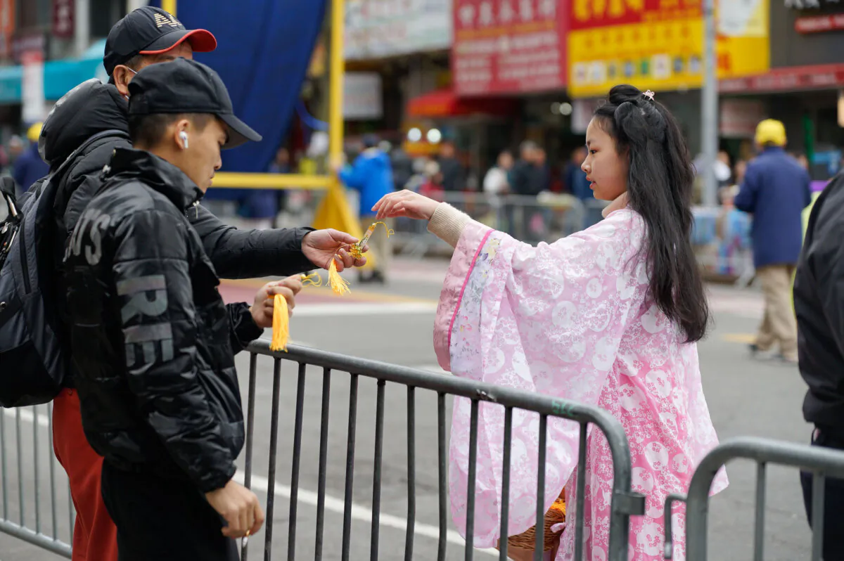 A Falun Gong practitioner hands out souvenirs