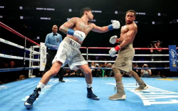 Ryan Garcia (white trunks) punches Devin Haney (gray trunks) during their WBC Super Lightweight title bout at Barclays Center in New York City on April 20, 2024. (Al Bello/Getty Images)