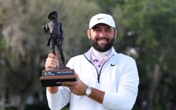 Scottie Scheffler of the United States celebrates with the trophy after winning during the continuation of the final round of the RBC Heritage at Harbour Town Golf Links in Hilton Head Island, S.C., on April 22, 2024. (Andrew Redington/Getty Images)