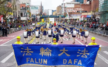 Falun Gong practitioners attend a parade to call for an end to the persecution in China of their faith, in the Flushing neighborhood of Queens, New York, on April 21, 2024. (Larry Dye/The Epoch Times)
