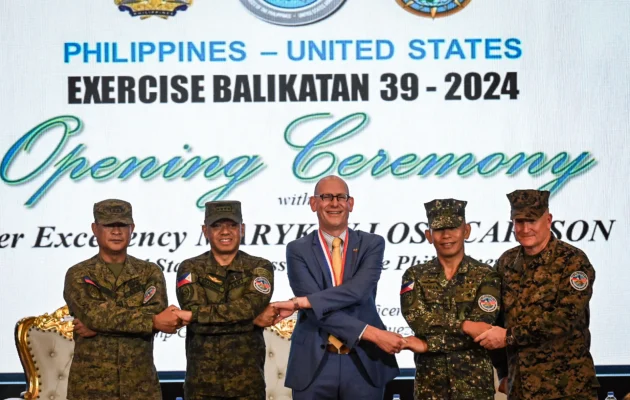 (From Left to Right) Philippines exercise director for Balikatan Major General Marvin Licudine, Armed Forces of the Philippines Chief of Staff General Romeo Brawner, US embassy in the Philippines Chargé d'Affaires Robert Ewing, Armed Forces of the Philippines deputy Chief of Staff for Education, Training and Doctrine Major General Noel Beleran and US exercise director for Balikatan Lieutenant General William Jurney link arms during the opening ceremony of the 'Balikatan' joint military exercise at the military headquarters in Quezon City, suburban Manila on April 22, 2024. (Jam Sta Rosa/AFP via Getty Images)