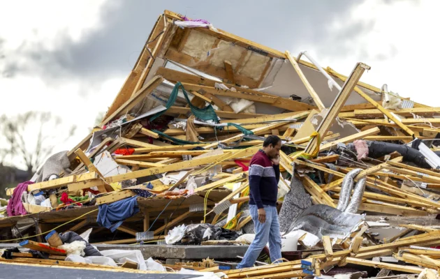 Gopala Penmetsa walks past his house after it was leveled by a tornado near Omaha, Neb., on April 26, 2024. (Chris Machian/Omaha World-Herald via AP)