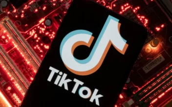 A smartphone with a displayed TikTok logo is placed on a computer motherboard in this illustration taken February 23, 2023. (REUTERS/Dado Ruvic)