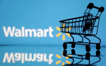 Shopping trolley in front of Walmart logo in an illustration on July 24, 2022. (Dado Ruvic/Illustration/Reuters)
