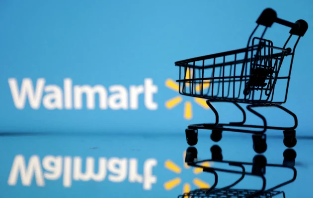 Shopping trolley in front of Walmart logo in an illustration on July 24, 2022. (Dado Ruvic/Illustration/Reuters)