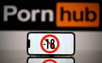 A screen displays a "no under-18s" sign in front of the logo of a pornographic website in this undated file photo. (Lionel Bonaventure/AFP via Getty Images)