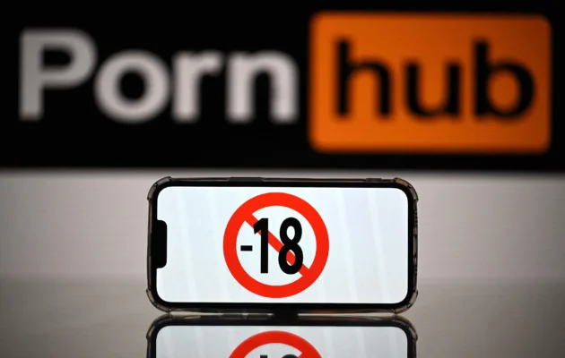 A screen displays a "no under-18s" sign in front of the logo of a pornographic website in this undated file photo. (Lionel Bonaventure/AFP via Getty Images)