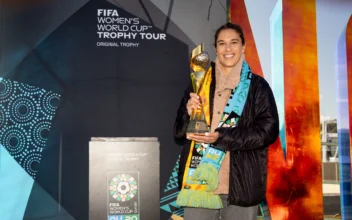 Former U.S. football player Carli Lloyd poses with the Women's World Cup trophy during a trophy promotion event in Wellington on July 14, 2023. (Photo by MARTY MELVILLE/AFP via Getty Images)