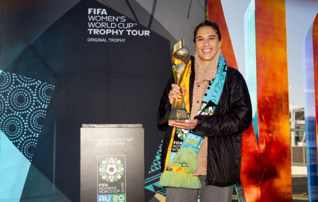 Former U.S. football player Carli Lloyd poses with the Women's World Cup trophy during a trophy promotion event in Wellington on July 14, 2023. (Photo by MARTY MELVILLE/AFP via Getty Images)