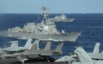 A Chinese military vessel (back R) - some 7-8 kilometres (five miles) away - observing as the Arleigh-Burke class guided missile destroyers USS Sterett (front) and the USS Rafael Peralta (behind) are seen from the deck of the USS Carl Vinson aircraft carrier as they join a three-day maritime exercise between the US and Japan in the Philippine Sea on Jan. 31, 2024. (Richard A. Brooks/AFP via Getty Images)