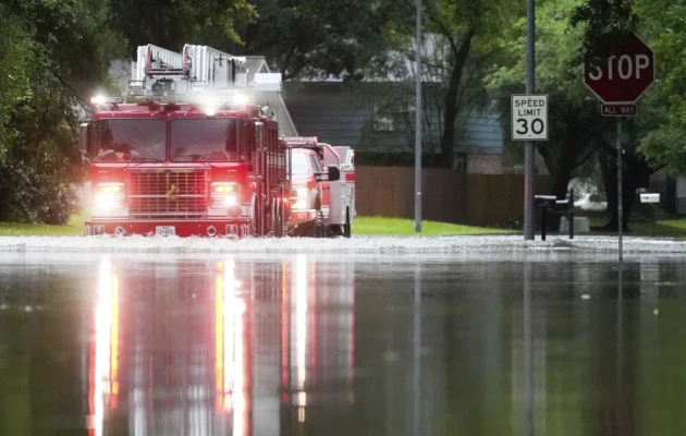 A Houston firetruck makes it way through flood water in North Woodland Hills after severe flooding in the Houston neighborhood of Kingwood on May 2, 2024. (Jason Fochtman/Houston Chronicle via AP)