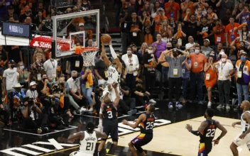 Giannis Antetokounmpo (34) of the Milwaukee Bucks dunks against Chris Paul (3) of the Phoenix Suns during the second half in Game Five of the NBA Finals at Footprint Center in Phoenix on July 17, 2021. (Christian Petersen/Getty Images)