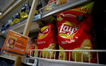A sign reading "Shrinkflation, This product has seen its weight decrease and the price charged by our supplier increase" at a Carrefour supermarket in Montesson near Paris, France, on Sept. 13, 2023. (Sarah Meyssonnier/Reuters)