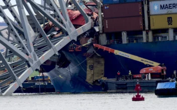 Workers remove wreckage of the collapsed Francis Scott Key Bridge in Baltimore on April 25, 2024. (Matt Rourke/AP Photo)