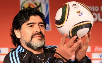 Argentina's head coach Diego Maradona holds up a match ball during a press conference at Loftus Oval in Pretoria, South Africa on June 11, 2010. (Chris McGrath/Getty Images)