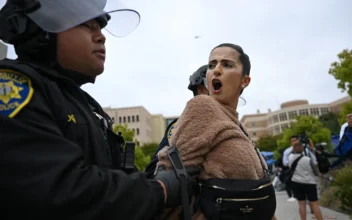 A pro-Palestinian demonstrator is arrested by police as an encampment is cleared after occupying and barricading the Physical Sciences Lecture Hall at the University of California, Irvine, in Irvine, Calif., on May 15, 2025. (Patrick T. Fallon/AFP via Getty Images)