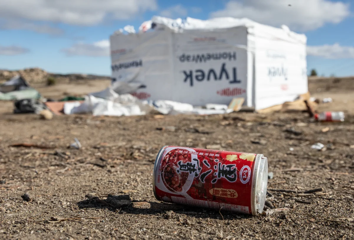 Chinese trash sits in a migrant encampment