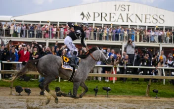 Jaime Torres, atop Seize The Grey, reacts after crossing the finish line to win the Preakness Stakes horse race at Pimlico Race Course in Baltimore on May 18, 2024. (Julio Cortez/AP Photo)