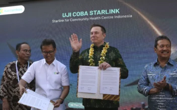 Indonesian Minister of Health Budi Gunadi Sadikin (2nd L) and Elon Musk (2nd R) pose after signing an agreement on enhancing connectivity at a public health center in Denpasar, Bali, Indonesia, on May 19, 2024. (Firdia Lisnawati/AP Photo)