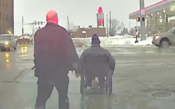 Police Officer Helps Wheelchair User Across Intersection
