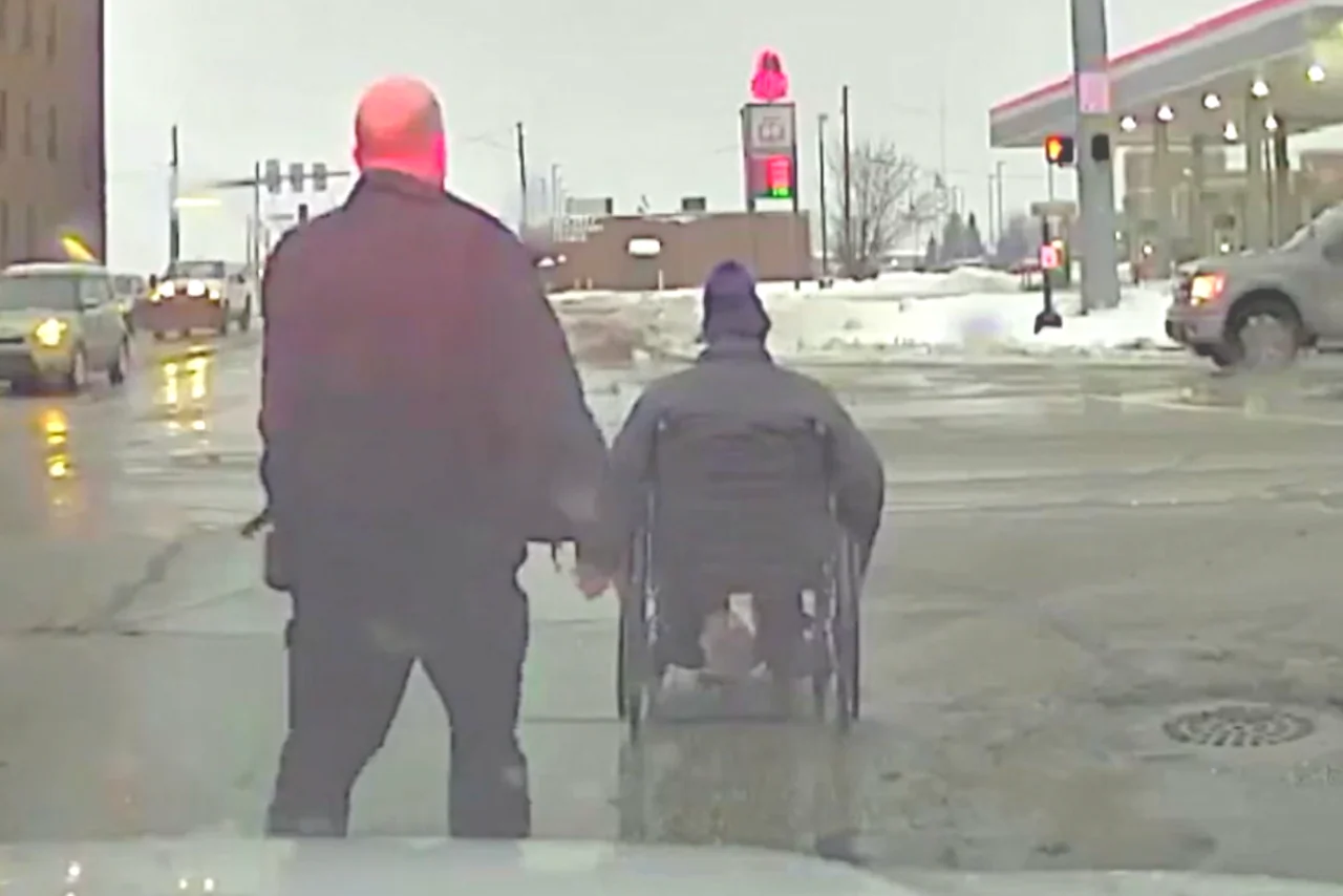Police Officer Helps Wheelchair User Across Intersection