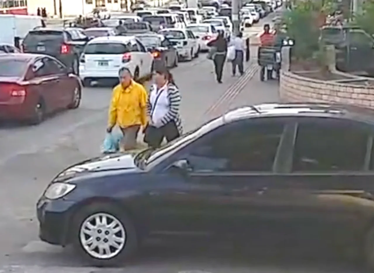 Pedestrians Walk on Car Blocking Crosswalk