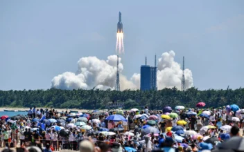 Onlookers watch the launch of a rocket transporting China’s second module for its Tiangong space station from the Wenchang spaceport in Southern China, on July 24, 2022. (CNS/AFP via Getty Images)