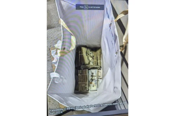 Cash from a bag that was left at the home of a juror in a massive fraud case, outside Minneapolis, Minn., on June 2, 2024. (U.S. Attorney's Office for Minnesota via AP)