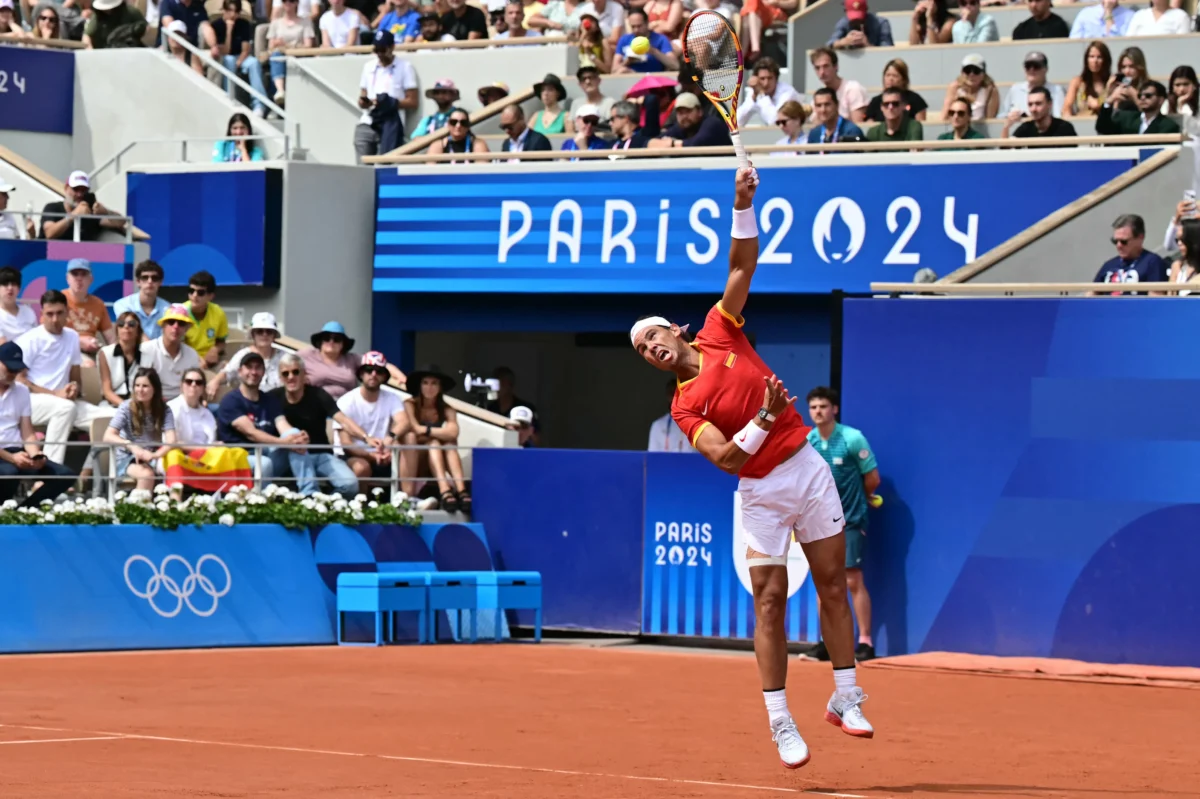 Rafael Nadal serves to Marton Fucsovics during their men's singles first round tennis match on Court Philippe-Chatrier at Paris 2024 Olympic Games, in Paris, on July 28, 2024. (Miguel Medina/AFP via Getty Images)