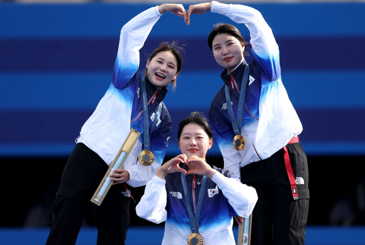 Gold medalists Hunyoung Jeon, Sihyeon Lim and Suhyeon Nam of Team Republic of Korea pose on the podium during the Archery medal ceremony after the Women’s Team event on day two of the Olympic Games in Paris, on July 28, 2024. (Alex Pantling/Getty Images)