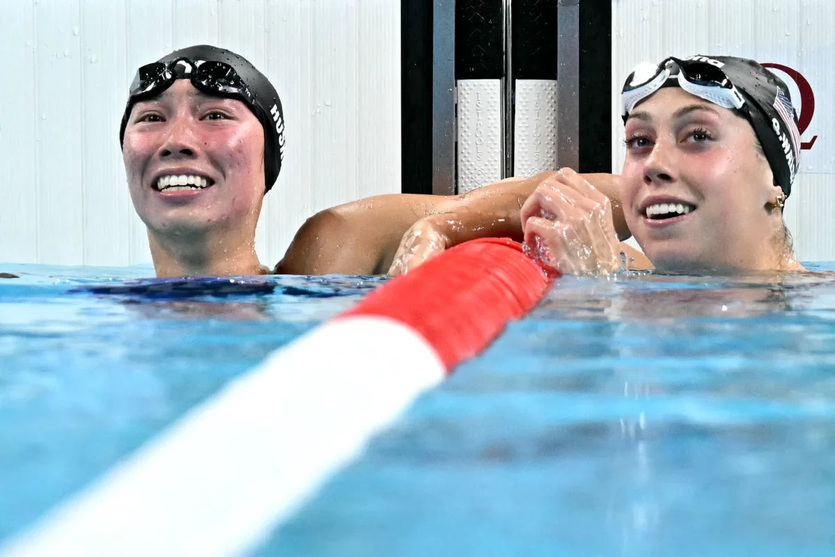 Torri Huske of the United States (L) celebrates with Gretchen Walsh after winning the final of the women's 100m butterfly swimming event during the Paris 2024 Olympic Games at the Paris La Defense Arena in Nanterre, west of Paris, on July 28, 2024. (Manan Vatsyayana/AFP via Getty Images)