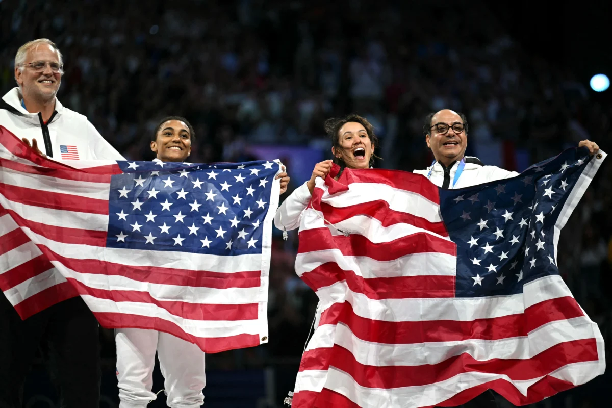 Silver medallist Lauren Scruggs (2nd L) and Gold medallist Lee Kiefer (2nd R) celebrate after winning in the women's foil individual gold medal bout during the Paris 2024 Olympic Games at the Grand Palais in Paris, on July 28, 2024. (Fabrice Coffrini/AFP via Getty Images)