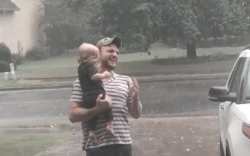 Baby Plays in Summer Rain With Father