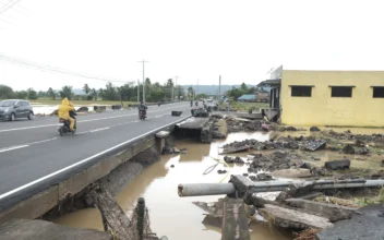 Debris from a damaged road and electric posts caused by Tropical Trami, locally named Kristine, in Polangui, Albay province, Philippines, on Oct. 23, 2024. (John Michael Magdasoc/AP Photo)