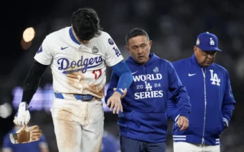 Los Angeles Dodgers' Shohei Ohtani is helped off the field after getting hurt during the seventh inning in Game 2 of the baseball World Series against the New York Yankees in Los Angeles Oct. 26, 2024. (Ashley Landis/AP Photo)