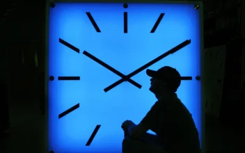 An Electric Time Company employee adjusts the color on a clock at the plant in Medfield, Mass., on Oct. 30, 2008, days before the switch to standard time. (Elise Amendola/AP Photo)