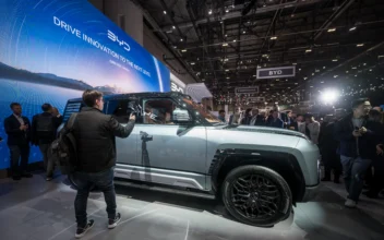 People are seen next to the BYD's Yangwang U8 giant SUV during a press day of the Geneva International Motor Show in Geneva on Feb. 26, 2024. (Fabrice Coffrini/AFP via Getty Images)