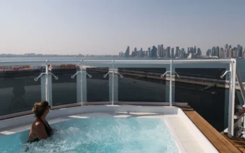 A woman looks out at the city skyline from a jacuzzi onboard a cruise ship.  (Giuseppe Cacace/AFP via Getty Images)