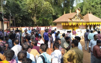 People gather at the Veerarkavu Hindu temple where an explosion occurred Monday night when a fireworks storage facility near by caught fire, during a festival at Neeleswaram, Kasargod district, southern Kerala state, India, on Oct.29, 2024. (AP Photo)